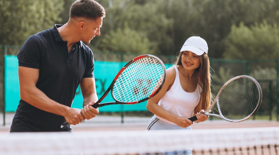 Couple playing tennis